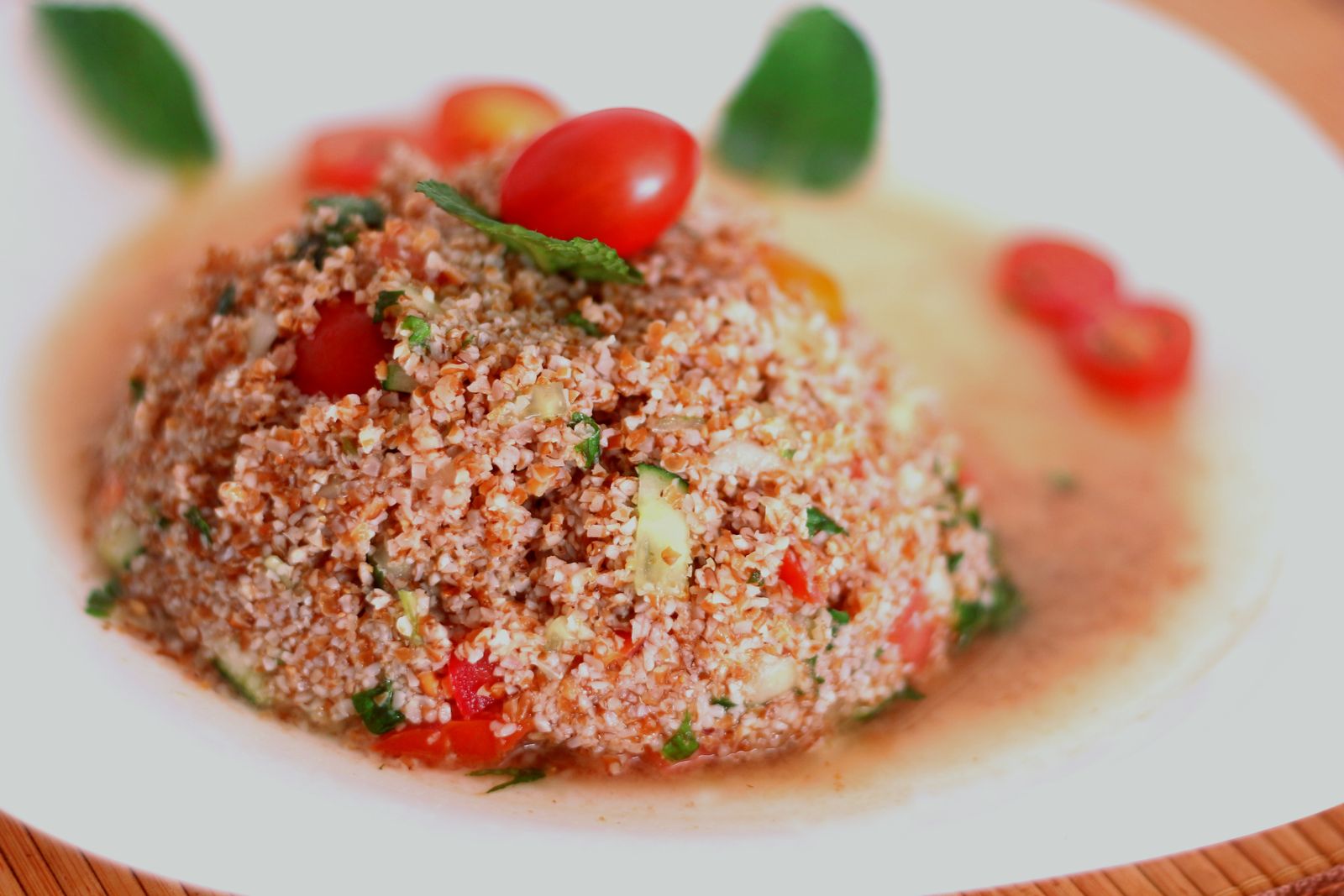 Bowl of tabbouleh made with bulgur wheat, tomatoes, and mint