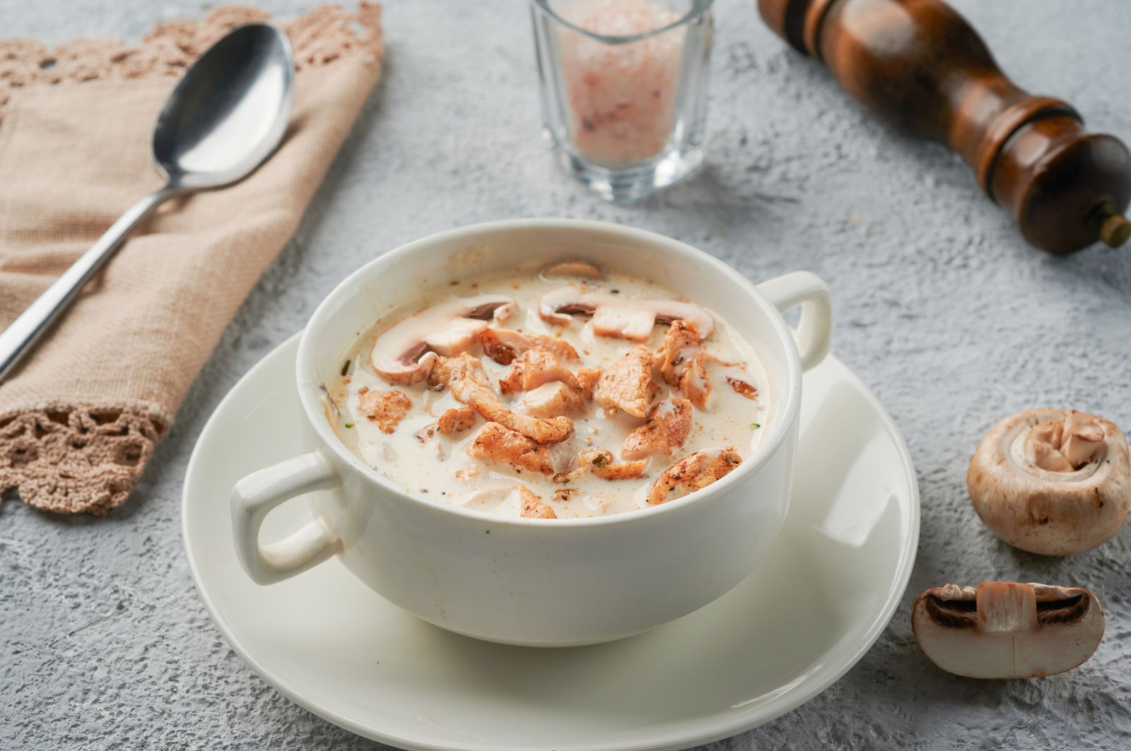 A bowl of creamy chicken and wild rice soup garnished with herbs