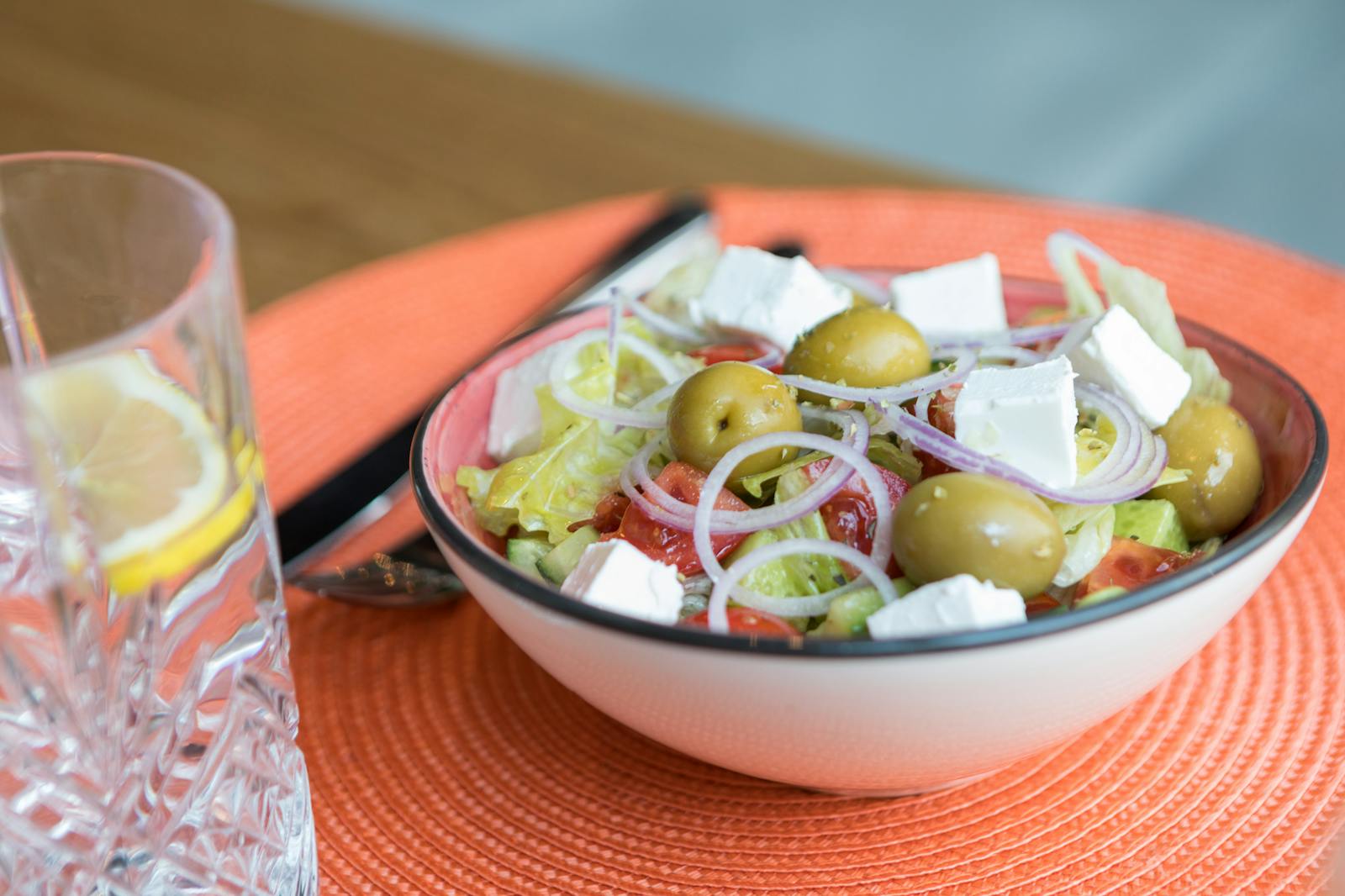 A bright bowl of Mediterranean salad with feta cheese, kalamata olives, tomatoes, cucumber, and red onion, the assembly behind this Greek quinoa salad recipe.