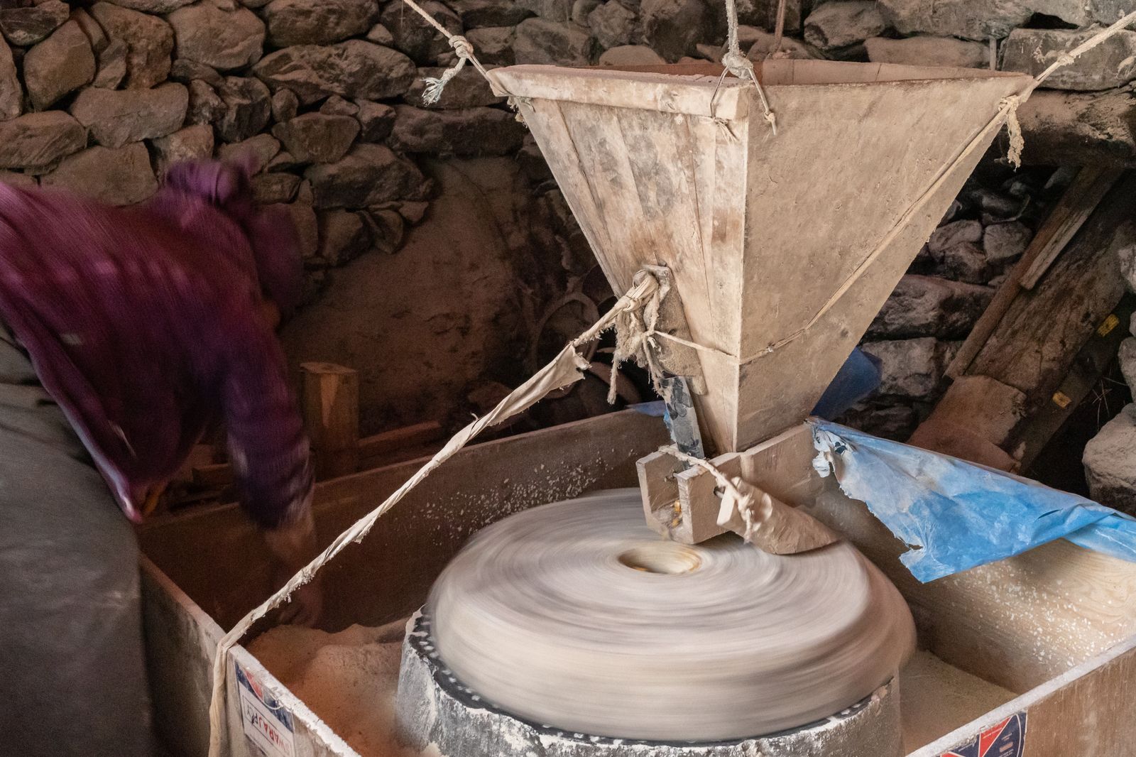 Traditional stone mill grinding grain into flour