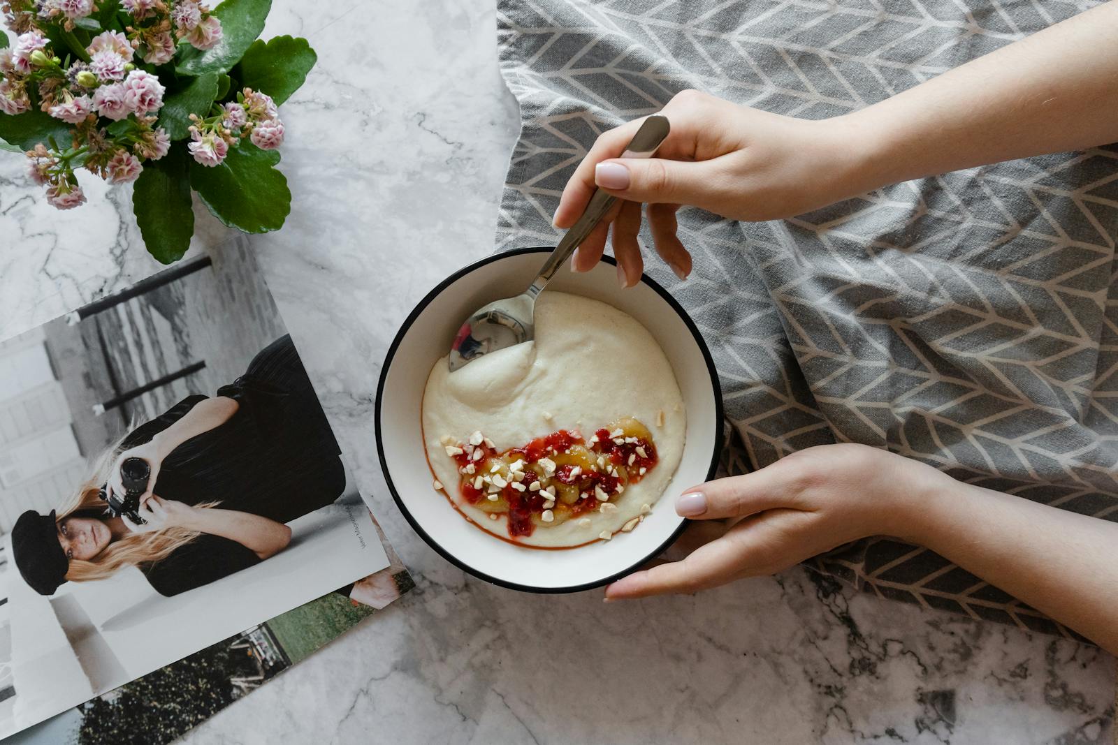 A warm bowl of grain porridge topped with fruit and nuts, the kind of breakfast that sorghum has been served as across West Africa and Ethiopia for thousands of years.