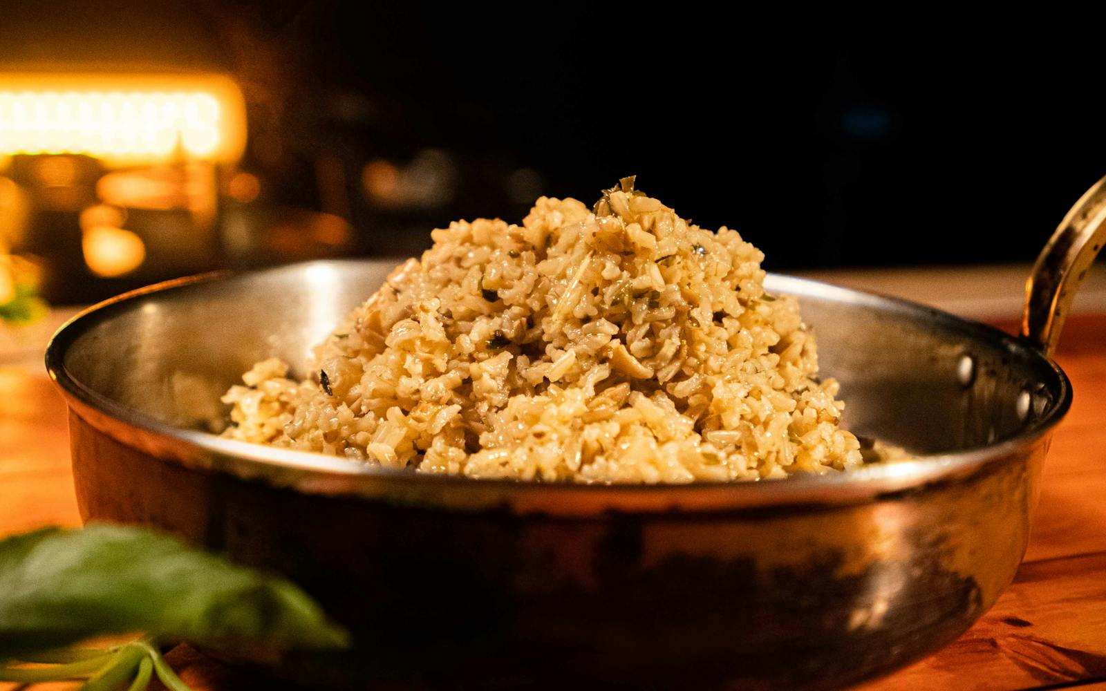 A copper pan filled with a creamy mushroom risotto, the kind of dish that spelt berries handle beautifully when finished risotto-style.