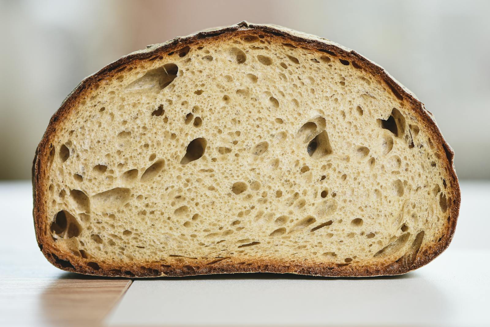 A close-up cross-section of an artisan sourdough loaf showing its open crumb, a visible result of the gluten network that the post discusses.