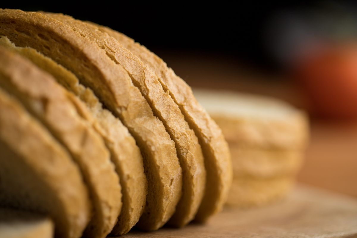 A sliced light-crumbed loaf on a board, the kind of structured gluten-free bread psyllium makes possible.