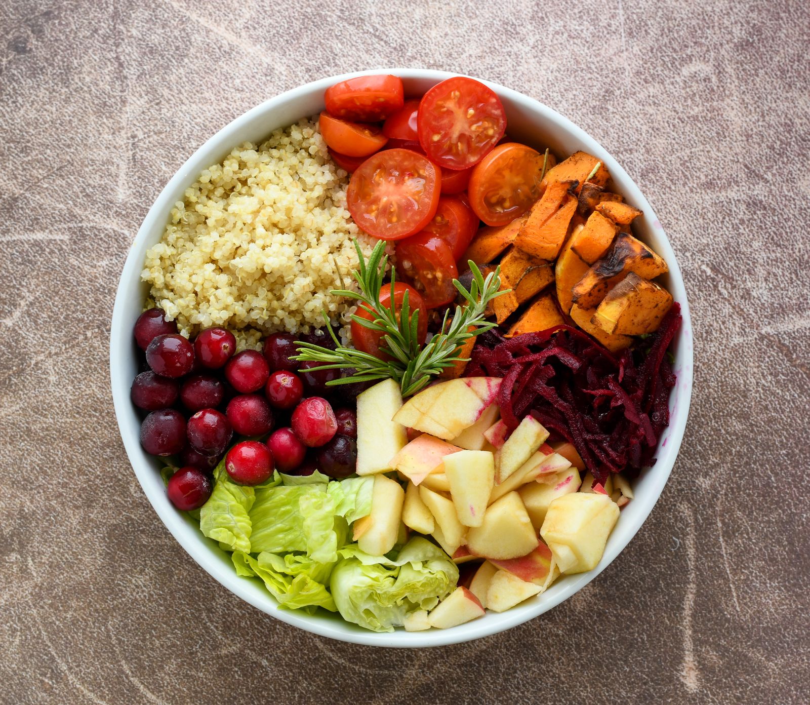 A vibrant bowl of cooked quinoa with fresh vegetables