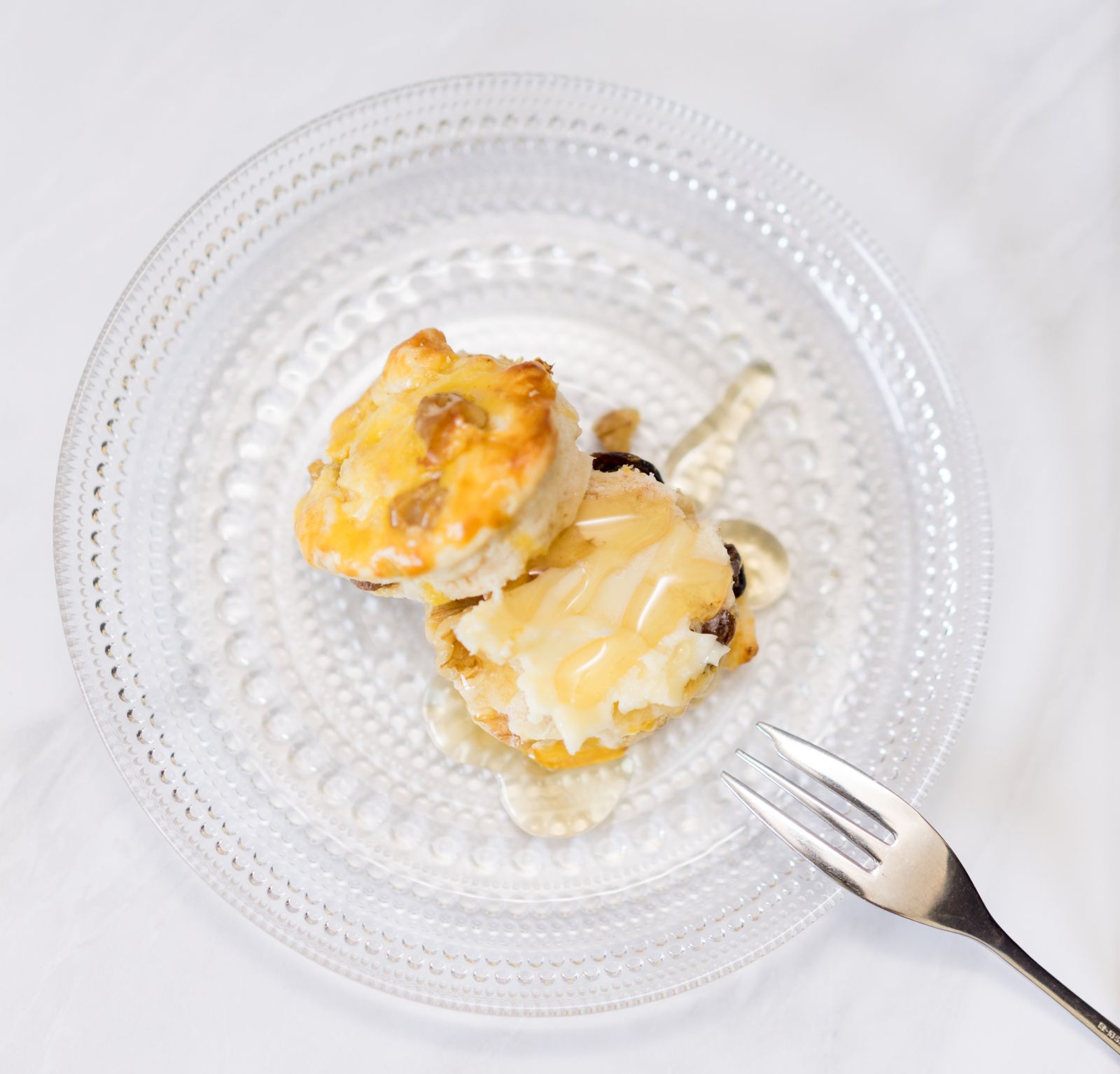Warm biscuits drizzled with amber syrup on a plate