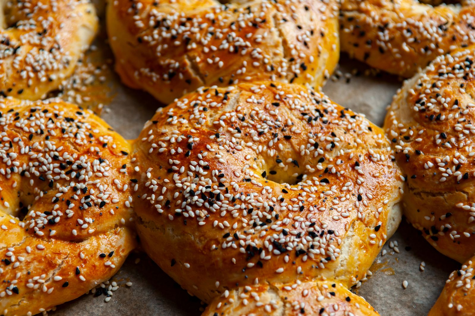 Golden brown bagels topped with sesame seeds straight from the oven