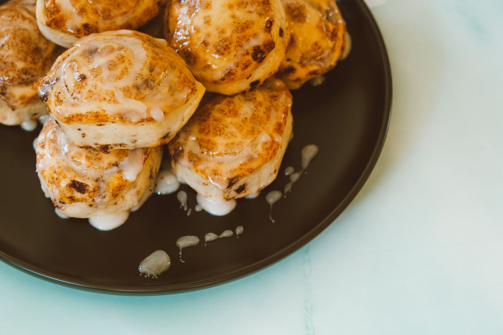 Close-up of freshly baked cinnamon rolls with icing