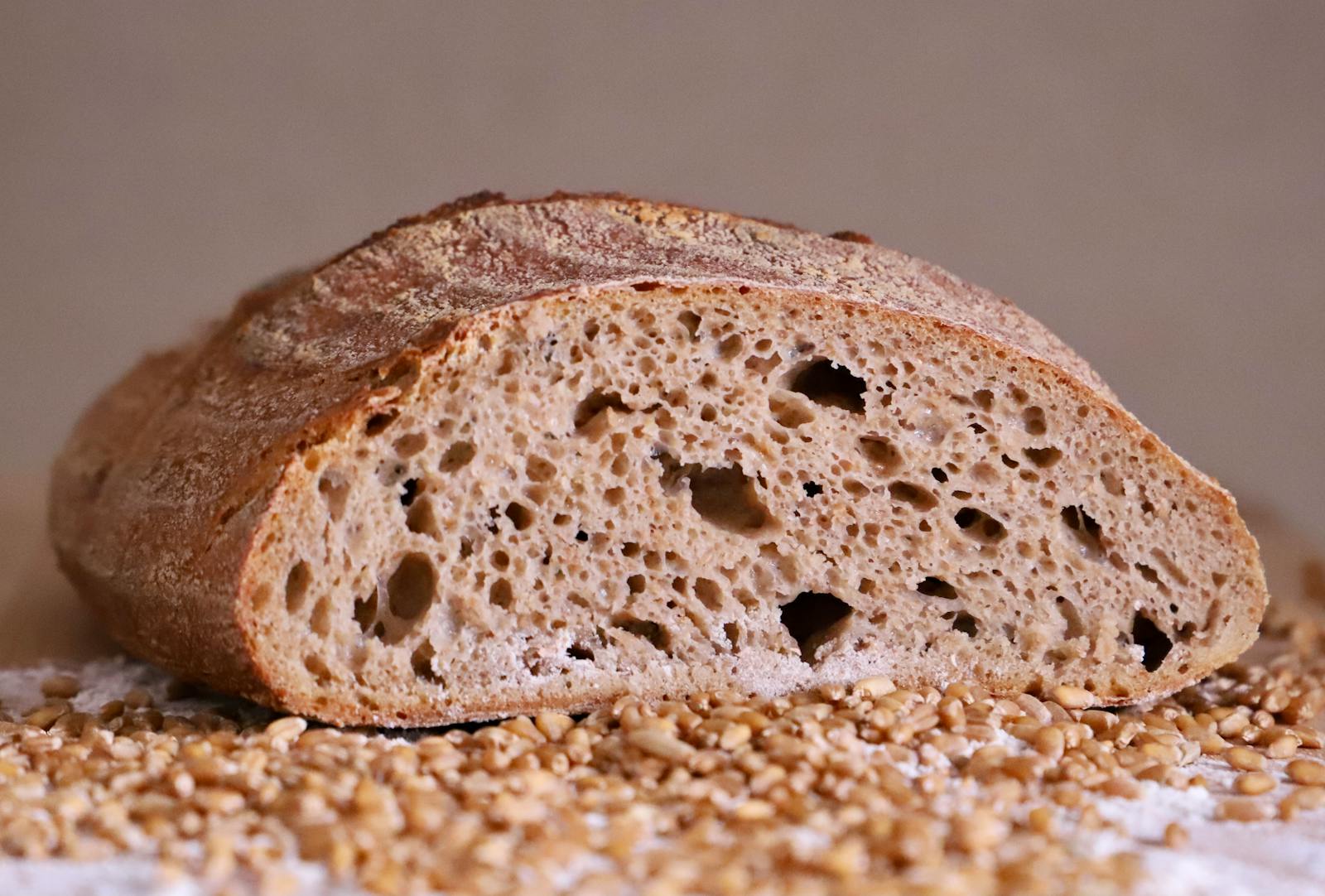 Rustic whole grain sourdough loaf with an open crumb
